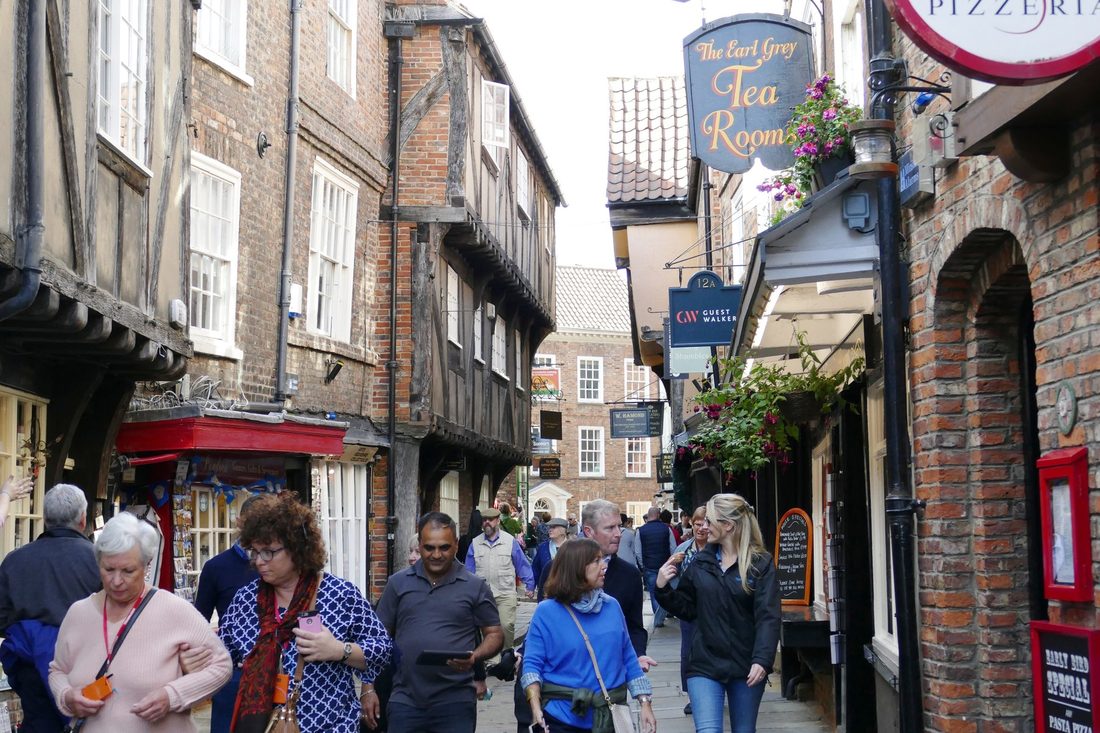 The medieval Shambles street in York, looking down a row of jettied timber-framed buildings, the same row that houses the Little Shambles Jewellers workshop above number 42